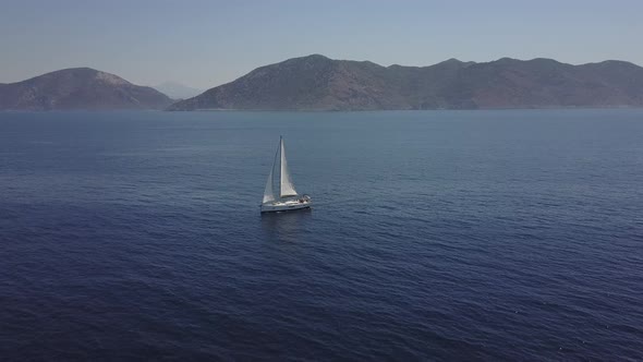 White Yacht on Mountains Background