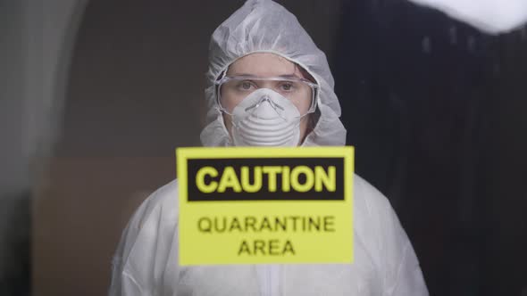 Woman in Protective Suit in Quarantine Zone. Coronovirus and Isolation Concept