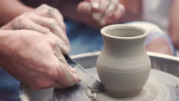 Grandmother with a Grandchildren Make Pitchers in Pottery