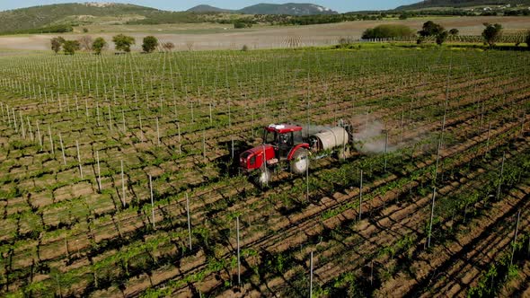 The tractor sprays fertilizes the fields with chemicals to protect crops from weeds and pests.
