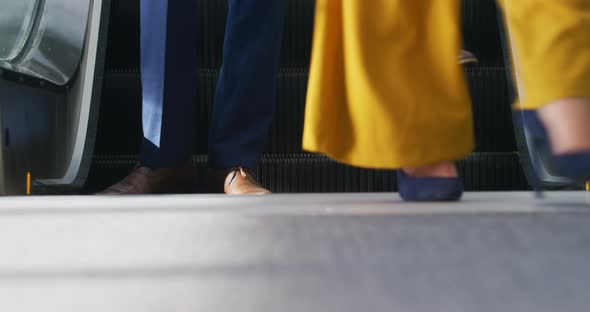 Business people on an escalator in a modern building