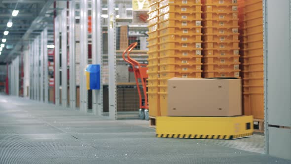 A Box is Being Driven By a Warehouse Robot