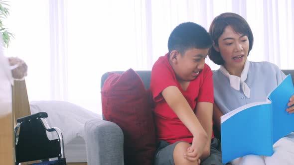 Asian mother caring for disabled son while living together at home