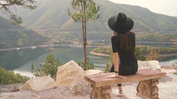 Lonely Woman Sitting on Bench and Enjoying Peaceful Mountain View