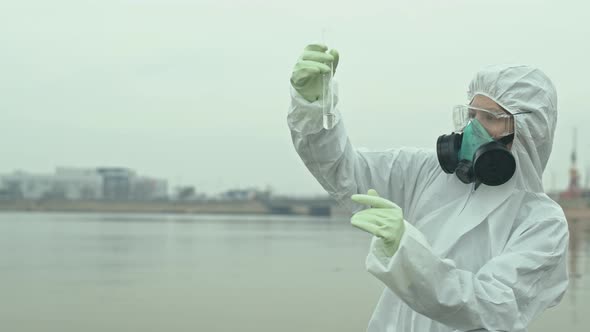 Ecology Expert Holding Test Tube with Polluted Water Sample