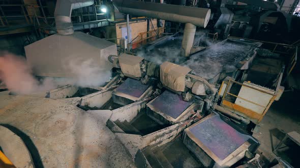 Factory Unit with Copper Plates Getting Submerged Into Hot Liquid