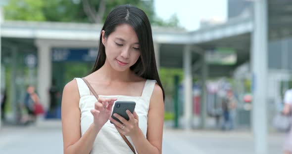 Young woman use the app on cellphone in city