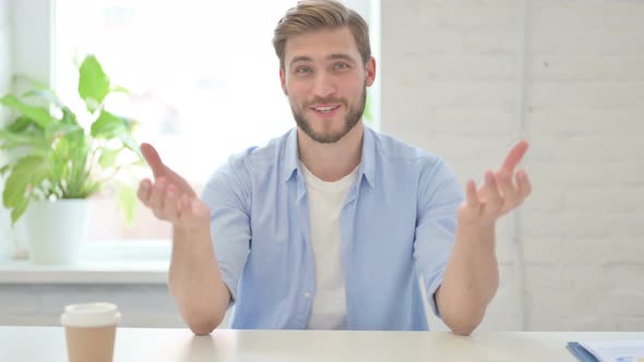 Young Creative Man Talking on Video Call in Modern Office