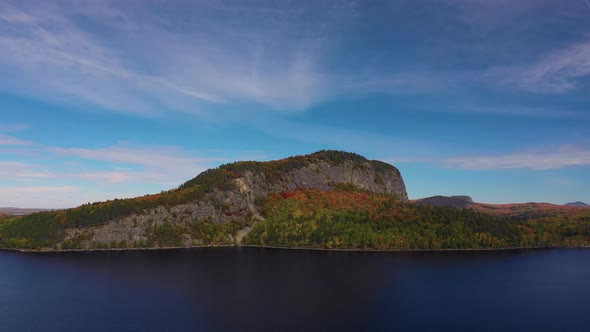 Aerial slide to right past Kineo Mountain over Moosehead lake in autumn