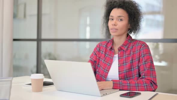 African Woman Shaking Head As No Sign While Using Laptop