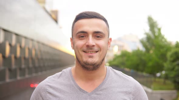 Portrait of happy smiling man in casual t-shirt looking at camera