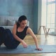 Woman in Tracksuit Does Supine Side Leg Raises on Grey Mat - VideoHive Item for Sale