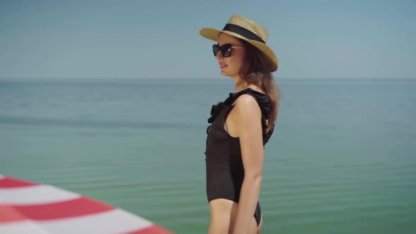 Slim Sensual Woman in Swimsuit Admiring Sea or Ocean at Sunny Summer Resort. Gorgeous Beautiful
