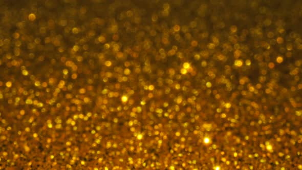 Gold glitter background with sparkling texture.