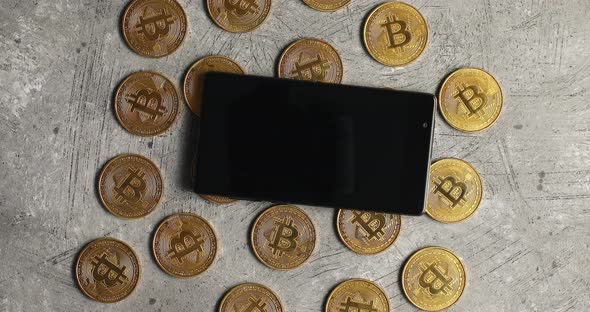 Smartphone and Bticoin on Gray Background