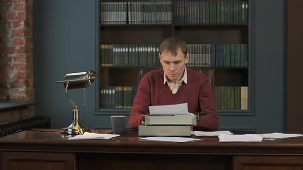 Male Writer Using Vintage Typewriter for Work