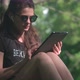 Young Woman Is Using Digital Tablet In Park - VideoHive Item for Sale