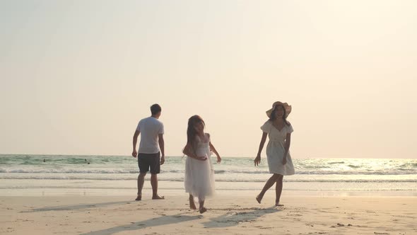 Asian Family playing together at beach with kids happy vacation travel beach concept