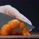 Person Holds Knife and Cuts Yellow Bell Pepper Into Slices - VideoHive Item for Sale
