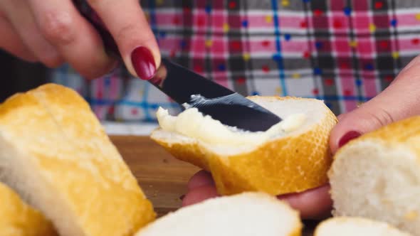 Female Hands Smear Butter on Bread