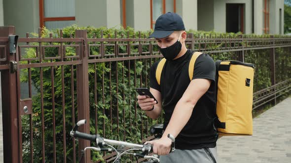 Delivery Man on Bicycle Checks Directions on Mobile Phone