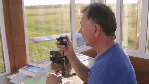 Airman Dispatcher Talking To Pilot By Walkietalkie and Discussing Flight Details Giving Permission