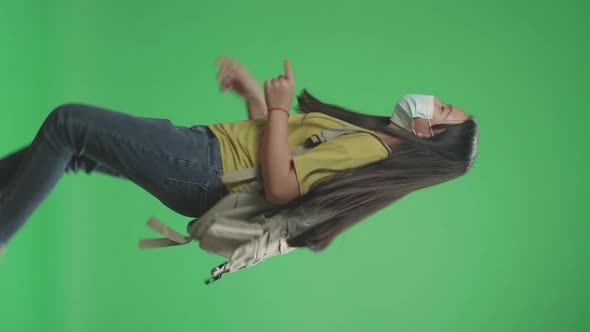 Side View Of Asian Girl Student Wearing Mask And Running To School On Green Screen Chroma Key