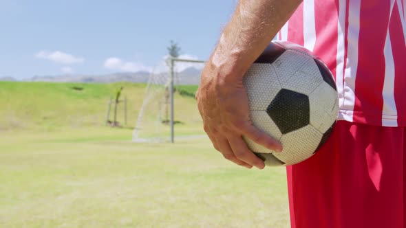 Soccer player holding ball