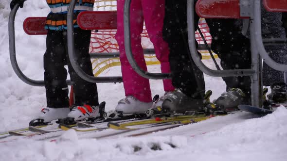 Skiers Pass a Turnstile Gates of Ski Lift. The Entrance of a Ski Chair Lifts with Skiers. Slow