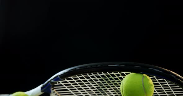 Close-up racket arranged on tennis balls