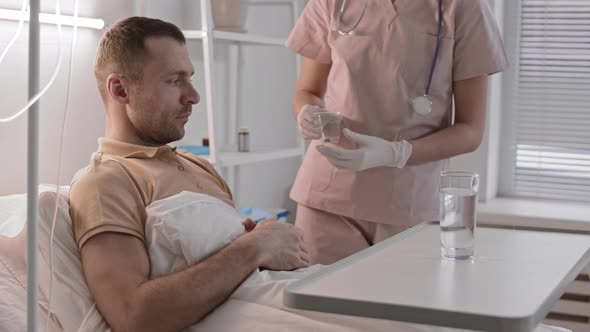 Nurse Bringing Pills to Sick Patient 