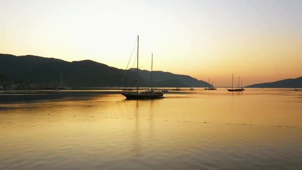 Sea Bay with Yachts and Mountains at Sunset