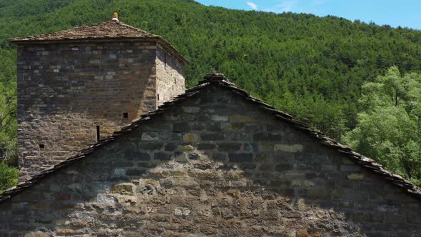 Aerial view above a mountain church in a valley