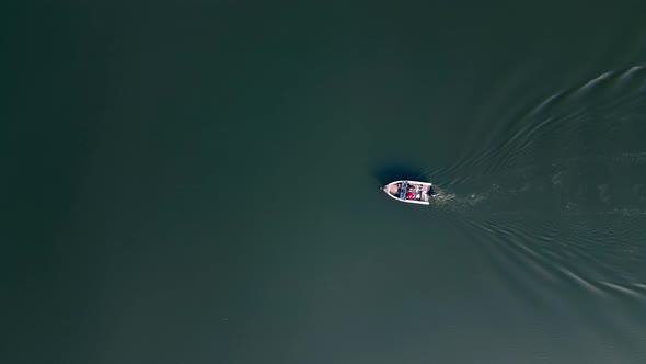 Aerial Top View of Motor Boat with Tourists Sails on the River