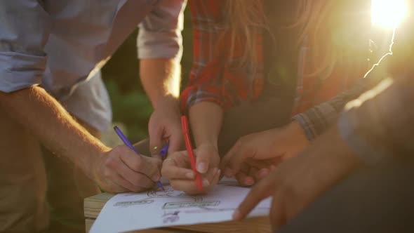 Three Interracial Female Standing Discussing Plan Underlining with Feltpens in Park in Slowmotion