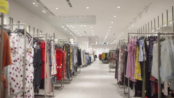 Racks with Clothing in Fashion Store