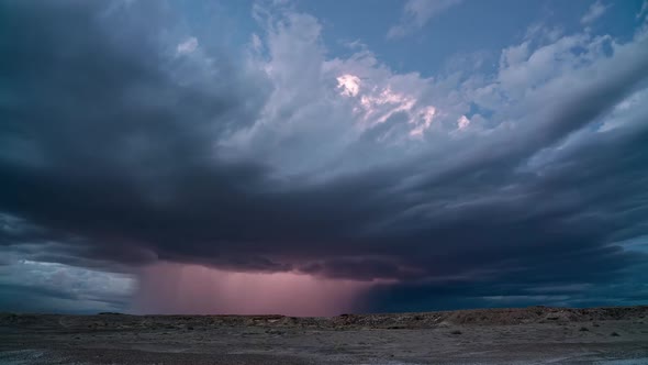 Lightning flashing in monsoon storm building in the Utah desert at dusk