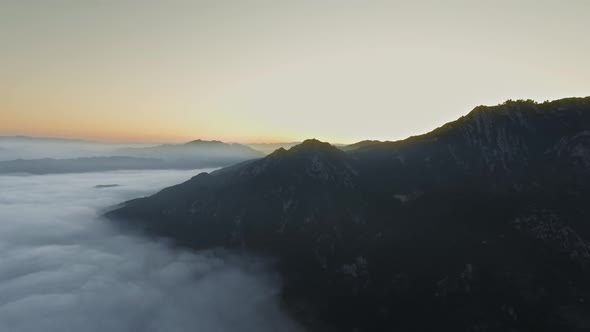 Drone camera flies through clouds and shoots the sun in Malibu Canyon, Calabasas, California, USA