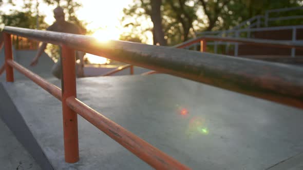 Silhouette of Skateboarder Doing a Tricks in a Concrete Skate Park During Sunset Slow Motion