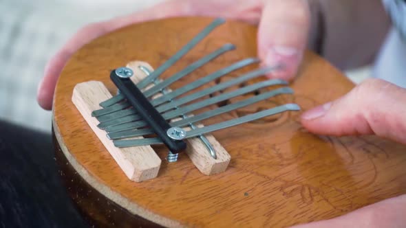 Mbira thumb piano played by young white man