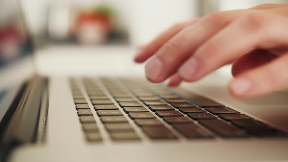 Close Up of a Person's Hands Typing on a Laptop Keyboard Indoors