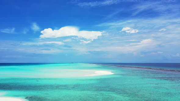 Beautiful fly over abstract shot of a white sandy paradise beach and aqua blue ocean background in h