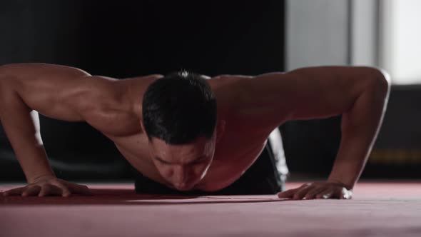 Athletic Young Man Does Low Push Ups with Clapping His Hands