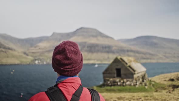 Man's Turned Back and a Beautiful View of the Hills and Ocean Waters