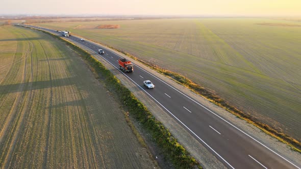 Aerial View of Cargo Trucks Driving on Highway Hauling Goods