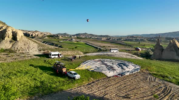 4K Aerial view of Goreme. Colorful hot air balloons fly over the valleys.