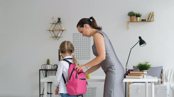 Mother Helping Daughter Get Ready for School