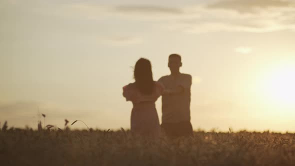 Romantic Happy Couple Dancing Together in Wheat Field