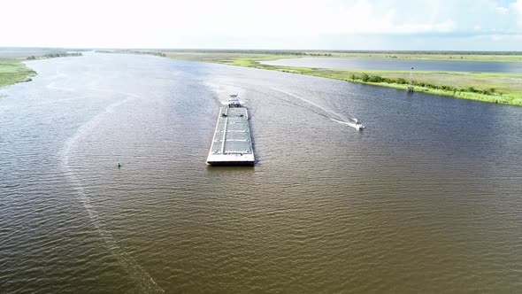 A Tugboat Guides a Barge Down the Apalachicola River to the Apalachicola Bay in Apalachicola, Florid