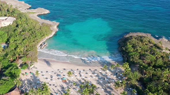 Caribe beach bay and tropical turquoise sea water, Dominican Republic. Aerial circle